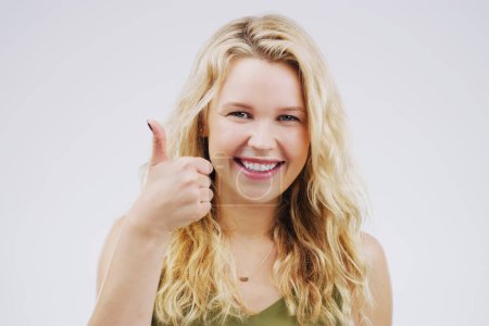 Photo for Portrait, smile and woman with thumbs up in studio for vote, voice or opinion choice on white background. Ok, hands and face of model with success, winner or emoji for praise, encourage or support. - Royalty Free Image