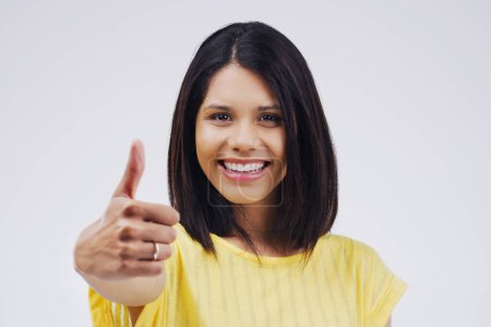 Photo for Studio, portrait and woman with thumbs up for approval, deal and yes with mockup. Agreement, face and happy female model with good hand gesture, satisfaction expression or sign by white background. - Royalty Free Image