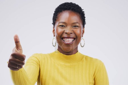 Photo for Portrait, smile and black woman with thumbs up in studio for vote, voice or opinion choice on white background. Ok, hands or model face with success, winner or emoji for praise, encourage or support. - Royalty Free Image