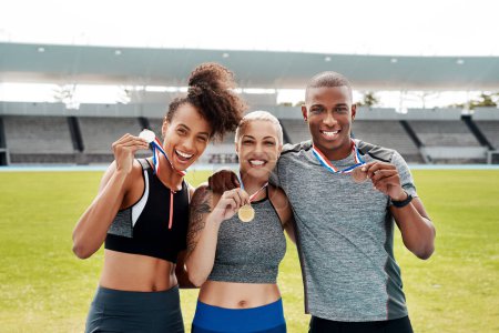 Photo for Portrait, people and running team with success in celebration of winners medal achievement in sports. Fitness, race event and happy athletes excited with pride, gold or victory in track and field. - Royalty Free Image
