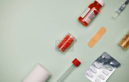 Medicine, drugs and pills for first aid on table in studio for healthcare and pharmacy product mockup. Medical, inventory and box or vitamins from drugstore and bandage to cure pain or care for sick.