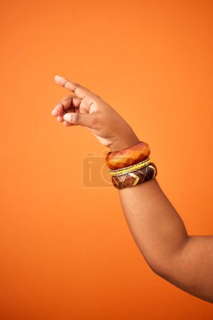 Photo for Woman, pointing with hand in studio for news or guiding for direction, answers and instruction to vote for party. Person, isolated and gesture or sign on mockup for promo, contact us and announcement. - Royalty Free Image