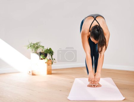 Photo for Bending, yoga or woman in home for stretching, wellness or body flexibility in zen studio for peace. Calm, downward facing dog or girl on mat for mindfulness, meditation or balance in pilates warm up. - Royalty Free Image