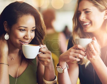 Photo for Smile, friends and women drinking coffee at cafe for conversation, communication or bonding. Happy girls, tea cup and talking at restaurant shop for morning gossip, story or relax together on bokeh. - Royalty Free Image