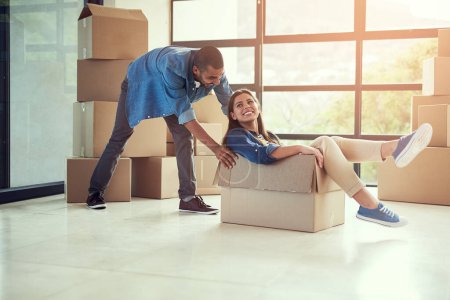 Photo for New home, playful and couple with box for moving for house, property mortgage and real estate investment. Homeowner, marriage and happy man and woman celebrate for relocation, packing and rental. - Royalty Free Image