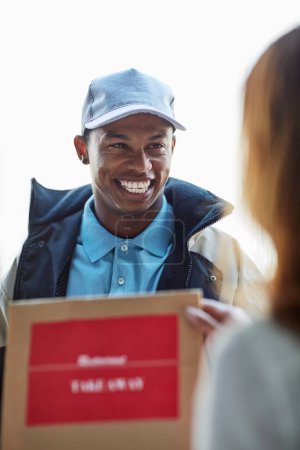 Photo for Smile, package and happy man at front door with food delivery for online shopping sales, distribution and takeout service. Ecommerce, customer and happy courier with paper bag, mail or post in home. - Royalty Free Image