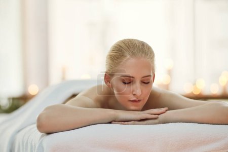 Photo for Woman, rest and bed at spa for wellness with thinking, memory and relax with aromatherapy candles. Girl, person and client at luxury resort with reflection, organic treatment and health on vacation. - Royalty Free Image