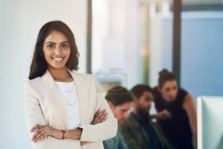 Photo for Indian woman, business and portrait with arms crossed in office with colleagues, professional or computer. Female person, face and tech startup as website software or game design, confidence or smile. - Royalty Free Image