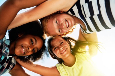 Photo for Happy, low angle and portrait of kids on camp for friendship, playing and fun together. Diversity, youth and girls huddle in circle for childhood, game and support at school, recess and playground. - Royalty Free Image