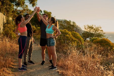 Photo for People, group and high five or mountain exercise as trail running support, fitness or victory. Men, women and hand gesture for training goals or sport target or friends celebration, morning or nature. - Royalty Free Image