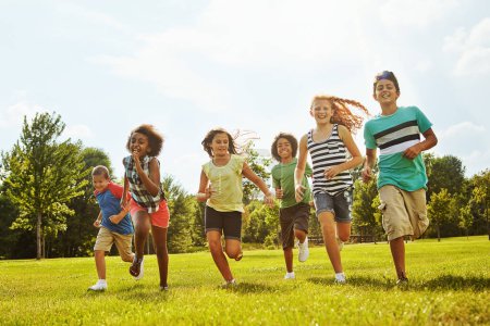 Photo for Happy children, diversity and running with friends in nature for fun, playful day or summer at park. Group of excited kids or youth enjoying sunny outdoor holiday or weekend on grass field together. - Royalty Free Image