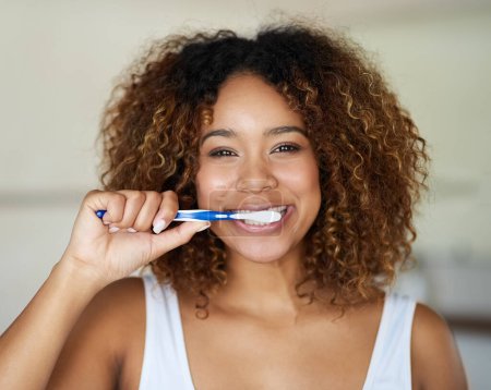 Photo for Black woman, portrait and toothbrush for smile with teeth in bathroom with dental hygiene in house. Happy, morning and everyday routine with refreshing breath, daily habit, getting ready and care. - Royalty Free Image