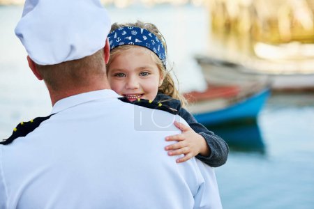 Photo for Father, child and marine uniform with hug or sailor captain at ocean for service duty, reunion or embrace. Man, daughter and happiness greeting for travel return or patriotic hero, family or navy. - Royalty Free Image