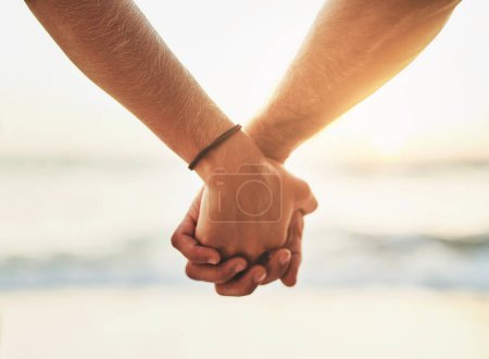 Photo for Couple, closeup and holding hands at beach for support or love, romance in relationship on holiday. People, zoom and palms together by ocean with trust on vacation, dating with travel in nature. - Royalty Free Image