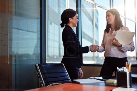 Photo for Business, deal and women with handshake in office for contract agreement, offer or onboarding negotiation. Thank you, documents people shaking hands for recruitment, welcome or b2b networking success. - Royalty Free Image