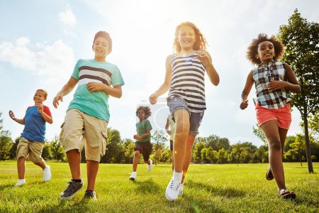Photo for Happy children, diversity and running with youth in nature for fun, playful day or summer at park. Group of excited kids or friends enjoying sunny outdoor holiday or weekend on grass field together. - Royalty Free Image