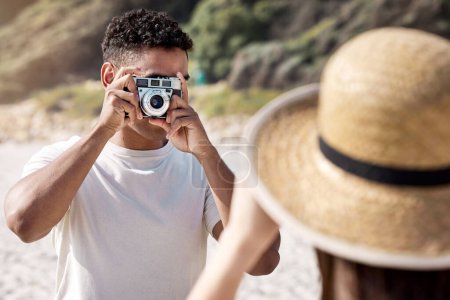 Photo for Man, camera and photography with woman at beach, couple on holiday for travel and memory together. Honeymoon, date or anniversary getaway with retro tech for picture taking and adventure outdoor. - Royalty Free Image