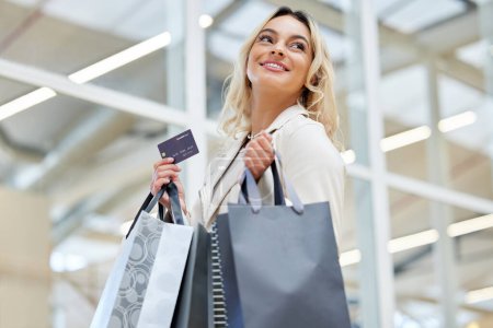 Photo for Shopping bag, fashion or happy woman with credit card in mall for bargain, choice or financial payment. Smile, sale deal or excited customer with package for purchase, clothes offer or retail promo. - Royalty Free Image