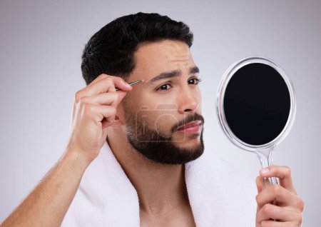 Man, mirror and tweezers for eyebrows with skincare isolated on white background with face. Beauty, routine and hygiene in morning for wellness or cleaning with microblading, natural and grooming