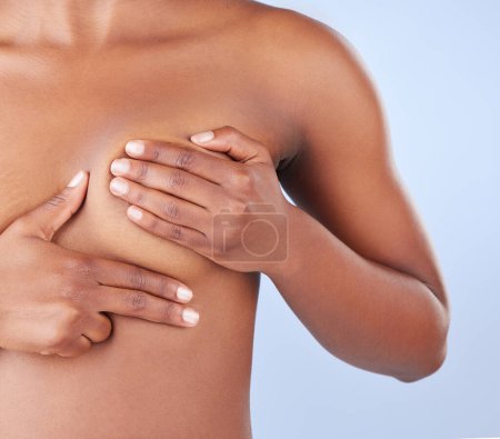 Body, naked woman and hands for breast cancer examination, search or wellness check in studio on blue background. Boobs, self assessment or model with fingers for lump, bump or diy tumor inspection.