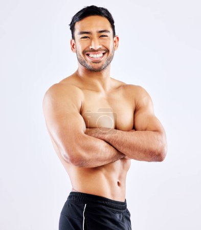 Photo for Happy asian man, portrait and muscular body with confidence for workout routine on a white studio background. Male person or bodybuilder with smile or arms crossed in fitness, exercise or weight loss. - Royalty Free Image