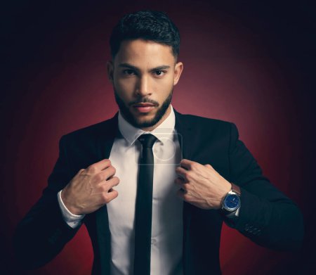 Photo for Portrait, business and gentleman with luxury, suit and confident guy on red studio background. Face, person and model with stylish clothes, corporate and professional with pride, handsome and fashion. - Royalty Free Image