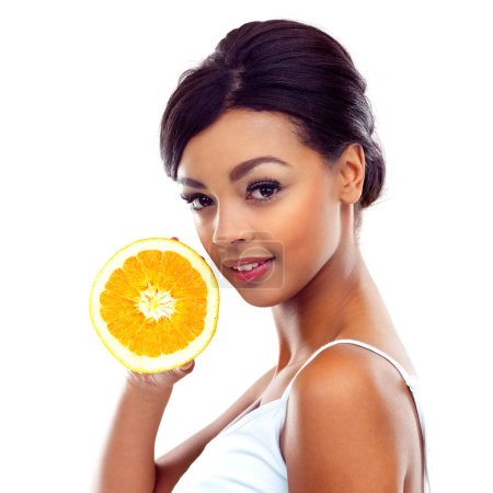 Photo for Portrait, diet and woman with orange, nutrition and sustainable eating to lose weight in studio. Citrus fruit, face and girl with fresh food for detox, vitamin c and gut health on white background - Royalty Free Image