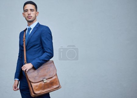 Photo for Thinking, business and man with bag, professional and corporate intern on grey studio background. Person, employee or consultant with satchel, mockup space and ideas with solution, choice or decision. - Royalty Free Image