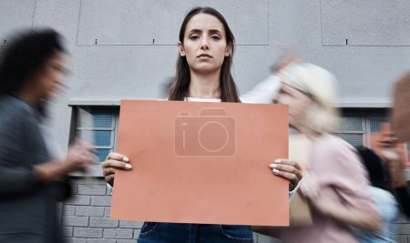 Photo for Woman, portrait and blank protest banner in busy city for change of government, politics and mockup space. Future, sign and group at rally outdoor for fight, human rights and revolution in Israel. - Royalty Free Image