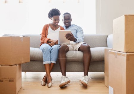 Foto de Black couple, social media and tablet with love, sofa in living room of new home for browsing together. App, smile or technology with happy man and woman in apartment for internet video streaming. - Imagen libre de derechos