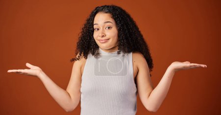 Photo for Portrait, woman and studio with comparison, choice and hand gesture on background with shrugging shoulders. Female person, options and doubt on backdrop in mockup space in indecision for alternatives. - Royalty Free Image