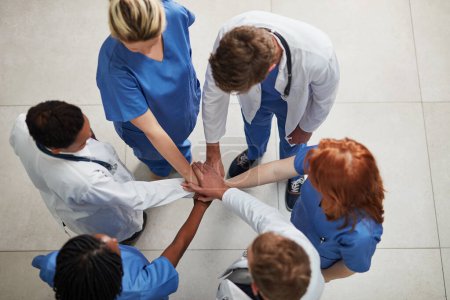 Photo for Top view, teamwork or hands of doctors in stack with mission in collaboration for healthcare support. Hospital clinic, people or group of medical nurses with solidarity, motivation or community help. - Royalty Free Image