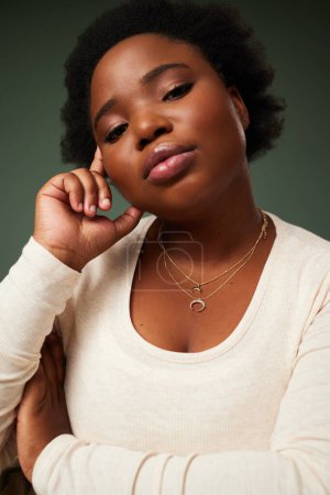 Photo for Black woman, portrait and thinking in studio with attitude, fashion and confidence on dark background. Female person, accessories and afro with hand on head for decision, choice and plus size style. - Royalty Free Image