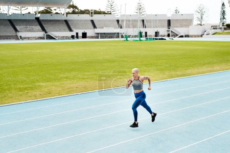 Photo for Athlete, woman and running on track for fitness, exercise and training, speed and endurance for marathon race. Active, female person and sport with energy, power and activity for competition. - Royalty Free Image