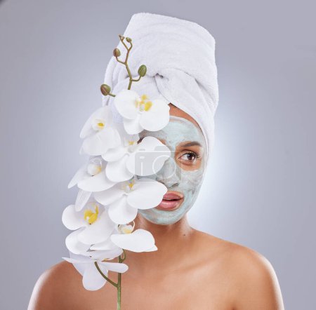 Photo for Orchid, woman and face mask for skincare, cosmetic and facial treatment on white background. Beauty, natural or organic for female person, plant and dermatology for detox and exfoliate product. - Royalty Free Image