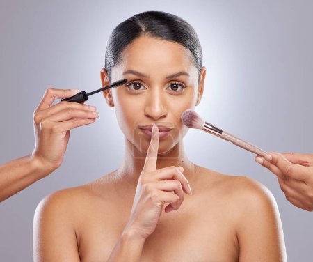 Woman, makeup brush and studio for beauty, hands and skincare on gray background. Cosmetology, portrait and secret gesture for facial treatment, tools and foundation for application or contour powder.