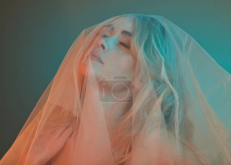 Photo for Fashion, fabric and woman with neon in studio for elegance, style and eyes closed on studio background. Art deco, textile and female person with mesh or veil, creative and glamour or makeup cosmetic. - Royalty Free Image