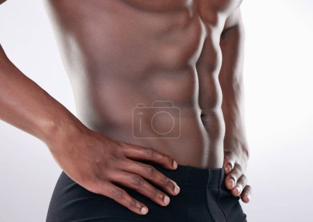 Photo for Black man, fitness and abs of bodybuilder in closeup for aesthetic human body isolated in studio. Sports, male person or model and topless with strong muscles for weight loss routine and wellness. - Royalty Free Image