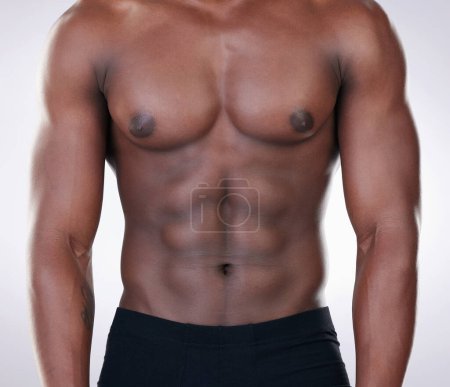 Photo for Fitness, black man and chest of bodybuilder in closeup for healthy body isolated in studio. Sports, male person or model and shirtless for strong muscles and weight loss routine from cardio - Royalty Free Image