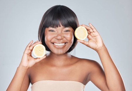 Photo for Skincare, portrait and black woman in studio with lemon for wellness, shine or dermatology treatment on grey background. Face, smile or happy girl model with fruit for citrus, benefits or skin detox. - Royalty Free Image