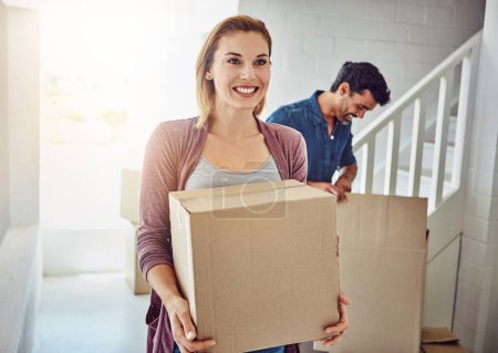 Photo for Couple, moving and new home with boxes, sunshine and happiness with mortgage, real estate and achievement. Apartment, man and woman with package, cardboard and property with lens flare and excited. - Royalty Free Image
