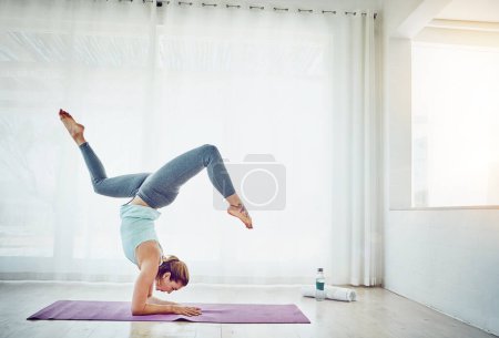 Photo for Yoga, woman and handstand on floor for fitness in home with balance, flexibility and arm strength. Pilates, yogi and exercise for strong core, wellness and healthy body with morning routine in lounge. - Royalty Free Image