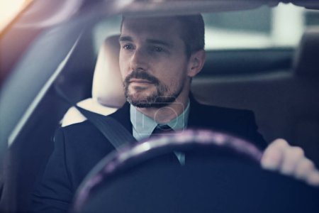 Businessman, thinking and driving in car for travel for commute to corporate work or job as entrepreneur of company. Man, motor vehicle and daily journey with transportation, traffic and on route