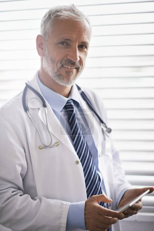 Photo for Hospital, clinic and portrait of doctor on tablet for medical results, research and online consulting. Office, healthcare and mature man on digital tech for website, telehealth service and wellness. - Royalty Free Image