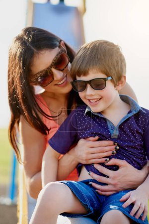 Photo for Woman, child and slide in playground for play, fun and park in summer. Boy, mother and parent with children in sunglasses and weekend activity, outing and together for relax and childhood development. - Royalty Free Image