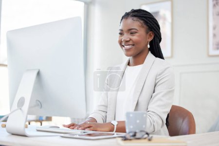 Photo for Computer, smile and black woman at desk, typing and internet or online in office. Technology, keyboard and planning for research and email, creative and copywriting for female person in workplace. - Royalty Free Image