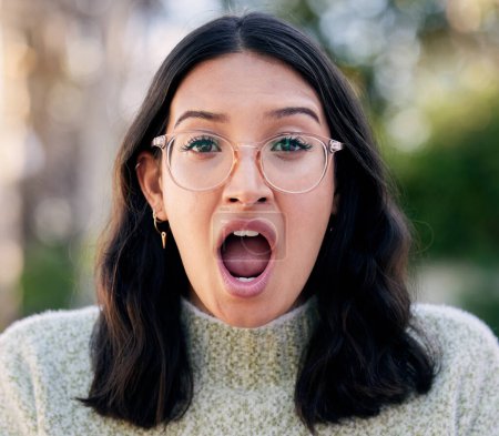 Woman, portrait and surprised of shocked for gossip, announcement and expression in nature. Emotion, face and wow or wtf emoji for female person, glasses and mind blown and amazed for secret or omg.