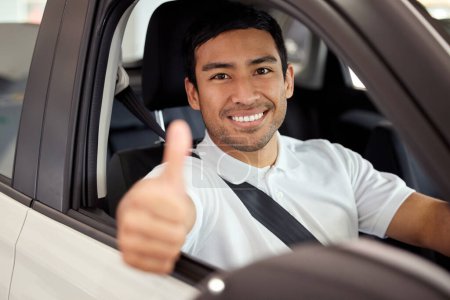 Photo for Happy, portrait and man in car with thumbs up for finance, sale or dealership agreement for insurance. Vehicle, safety and customer with choice at showroom and driver thank you for luxury transport. - Royalty Free Image
