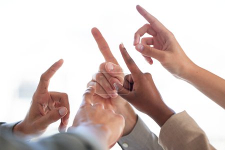 Foto de Group, hand and point together in studio, diversity and solution or business people or corporate employees. Teamwork, idea for project or answer in meeting, inclusion and united in professional work. - Imagen libre de derechos