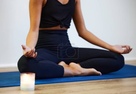 Photo for Woman, yoga mat and candle in home with lotus or hands, technique with flame for meditation. Female person and exercise pad with light for wellness in living room, mind or body and soul for chakra. - Royalty Free Image